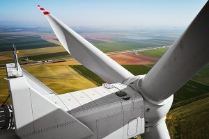 Aerial view of close up windmill turbine in countryside area, Wind power and renewable sustainable energy concept
