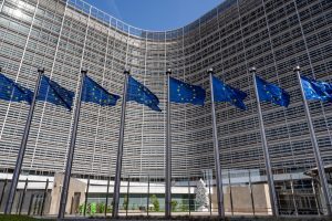 European flags in front of headquarters of European commission in Brussels in summer day.